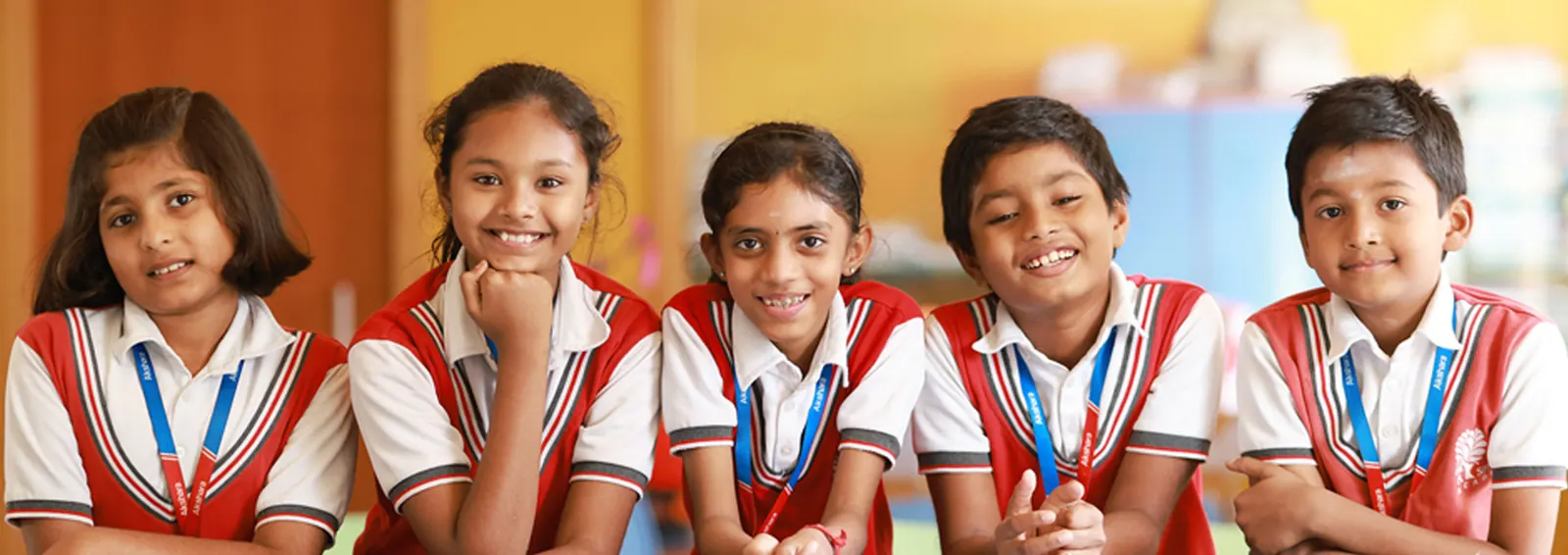 Young Aksharites smiling in their school uniform