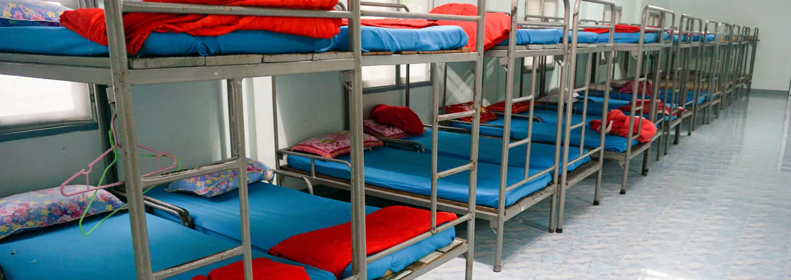 Rows of bunk beds in an Akshara hostel dormitory